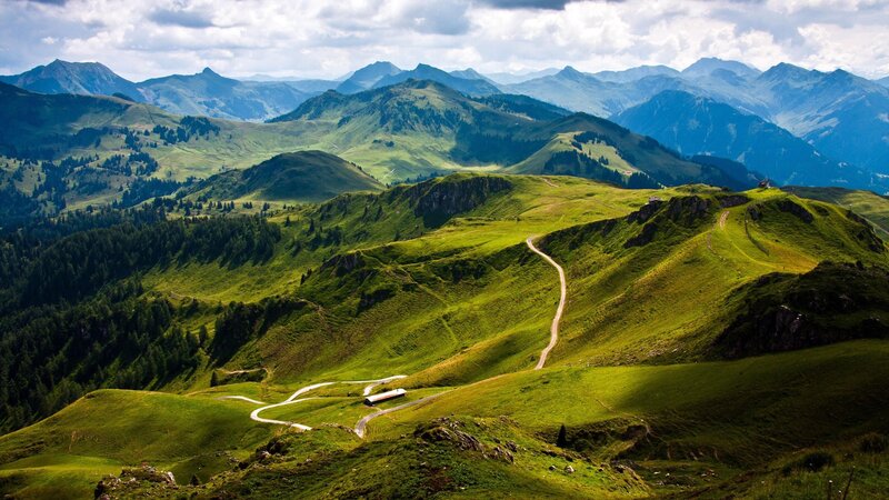 Winding mountain road through green hills