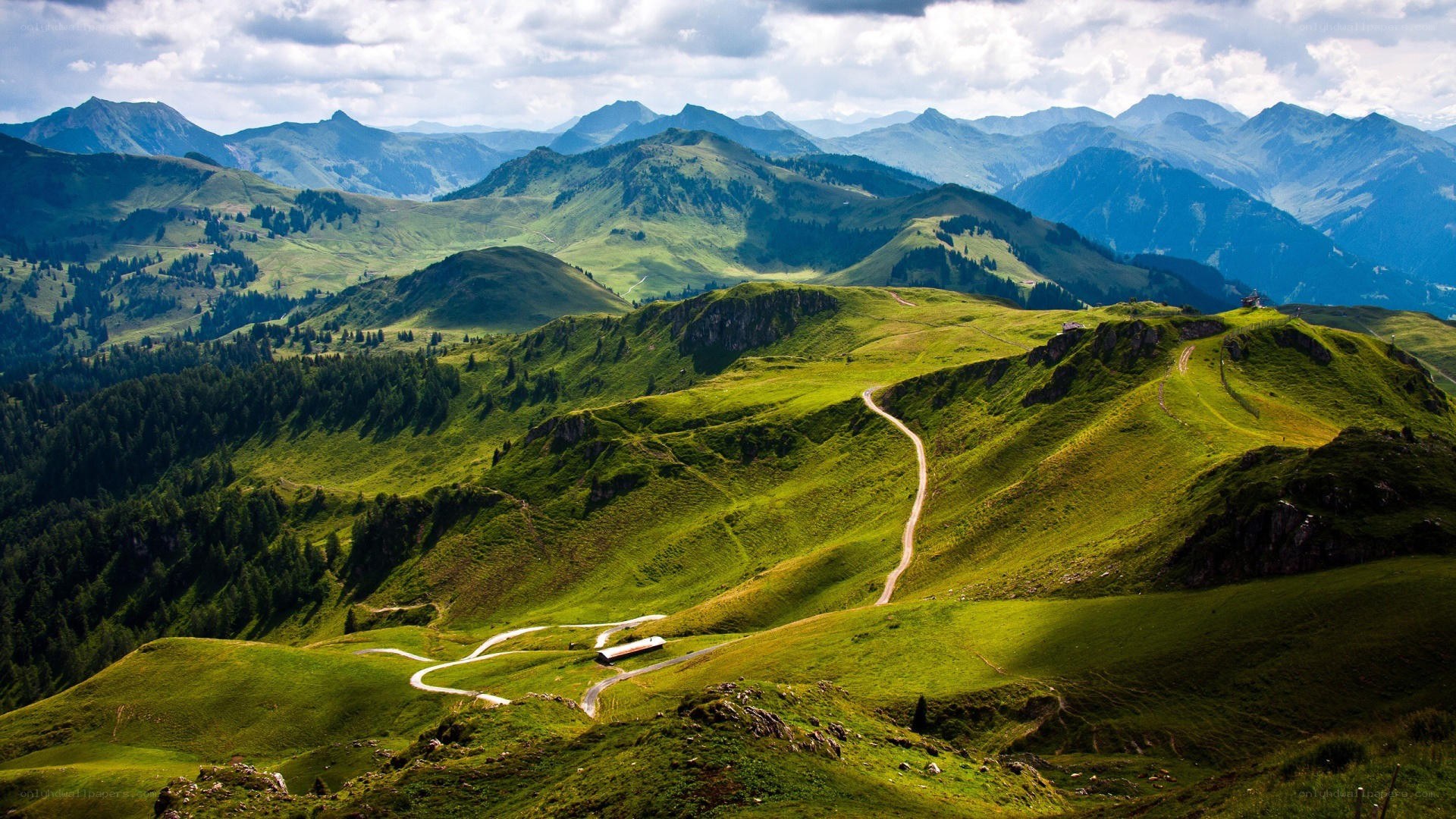 Winding mountain road through green hills