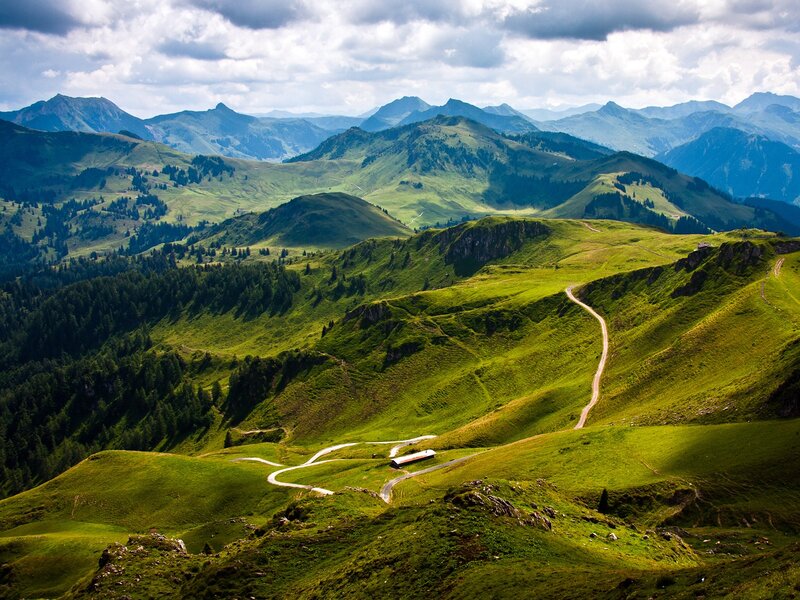 Winding mountain road through green hills