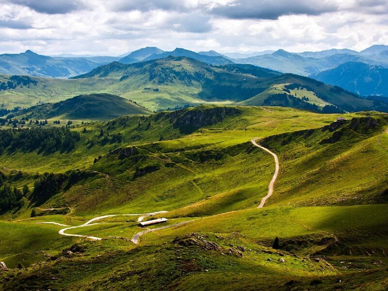 Winding mountain road through green hills