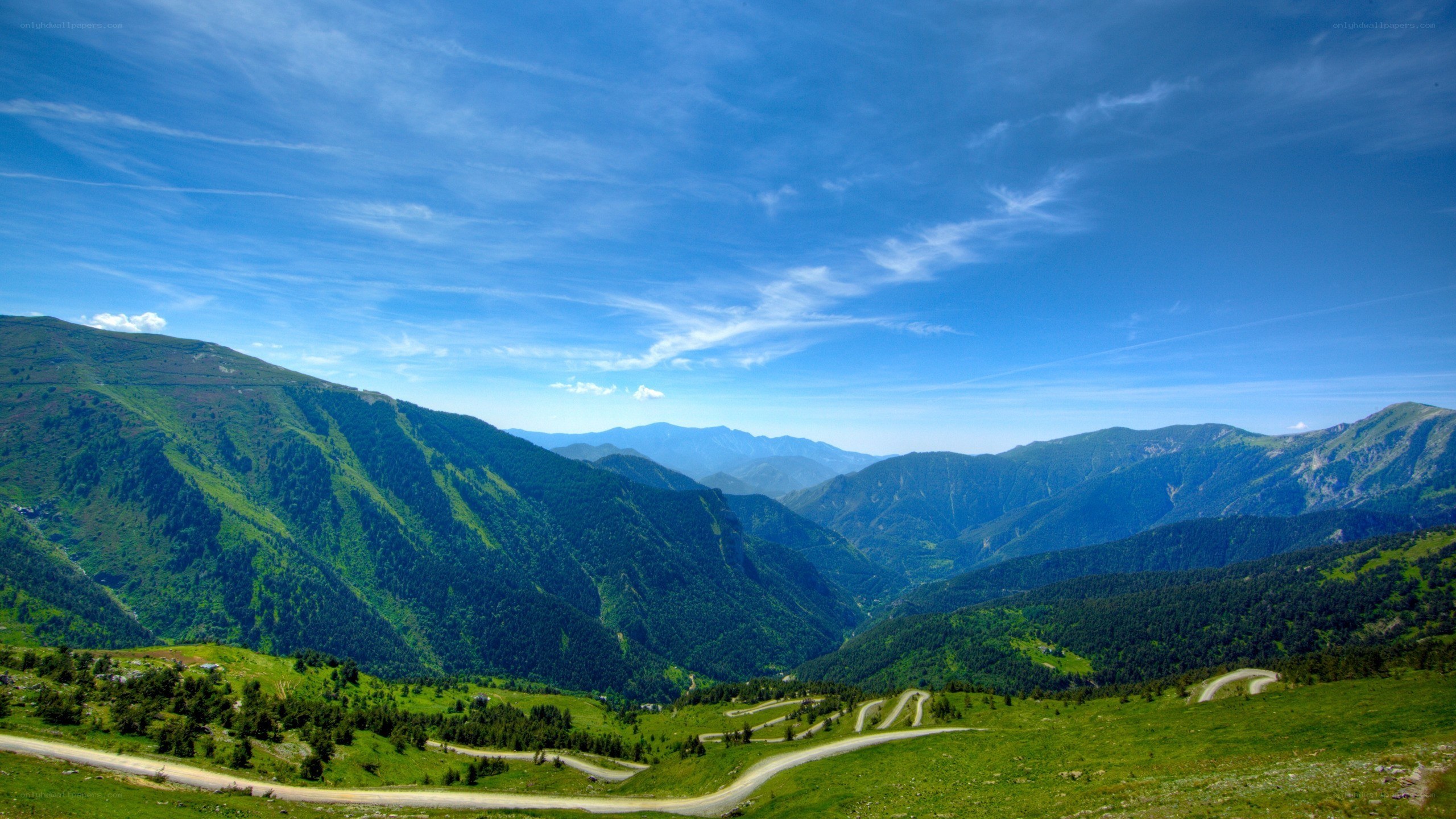 Winding mountain road under blue sky