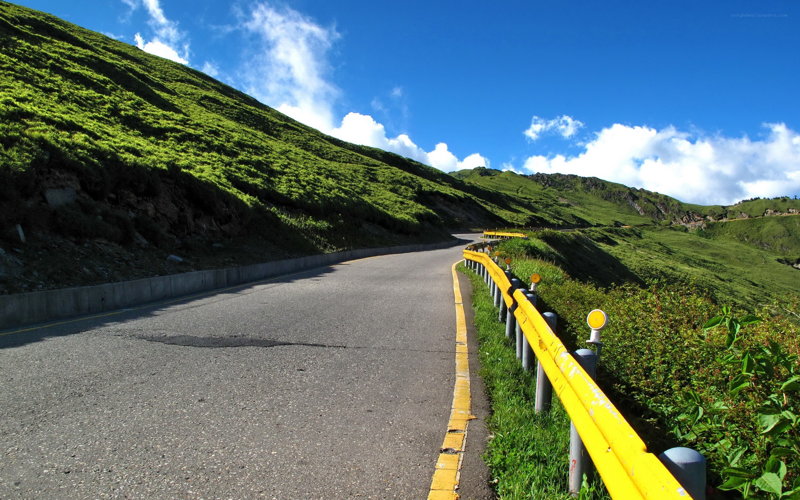 Winding mountain road under blue sky