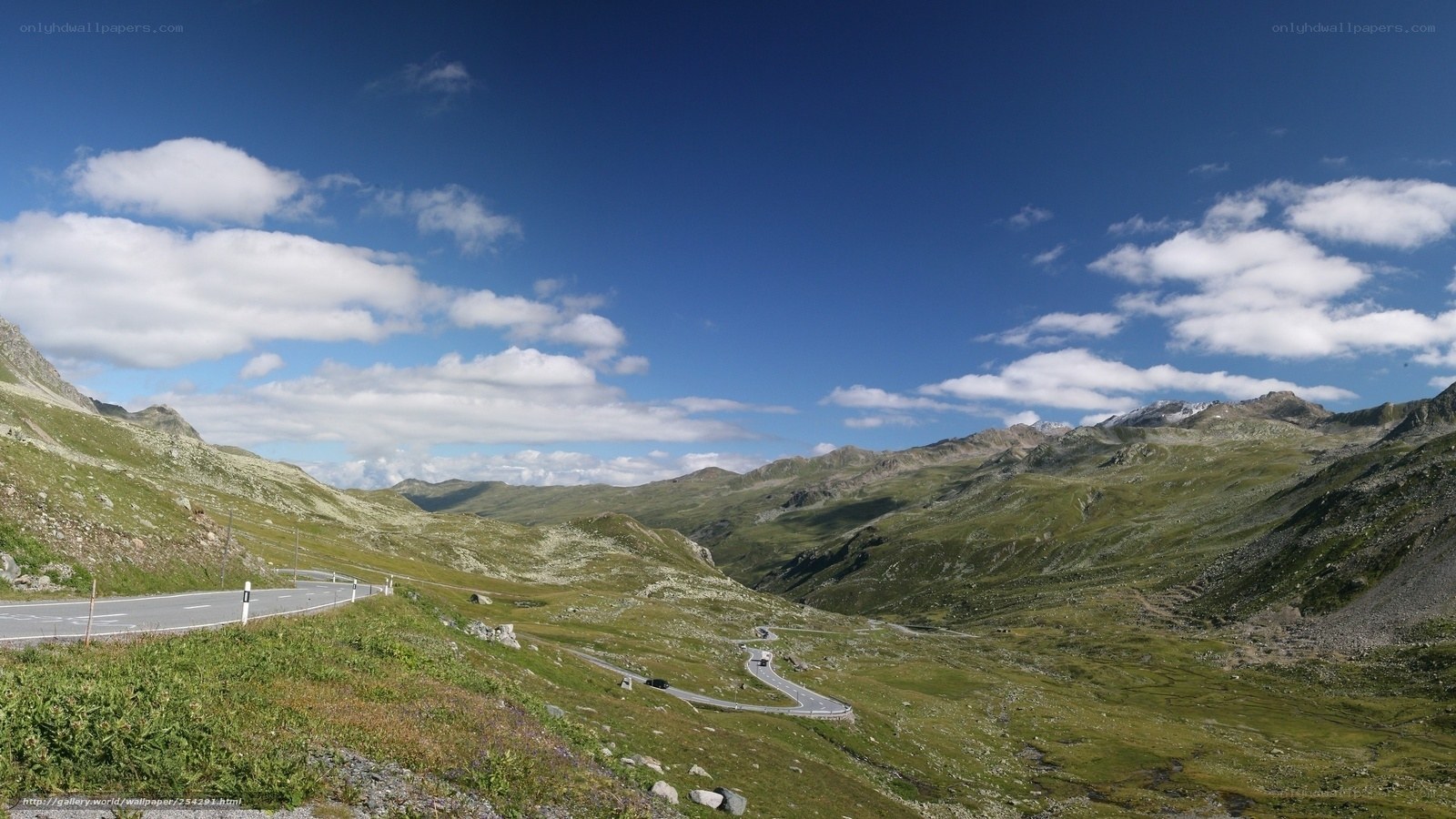 Winding mountain road under blue sky