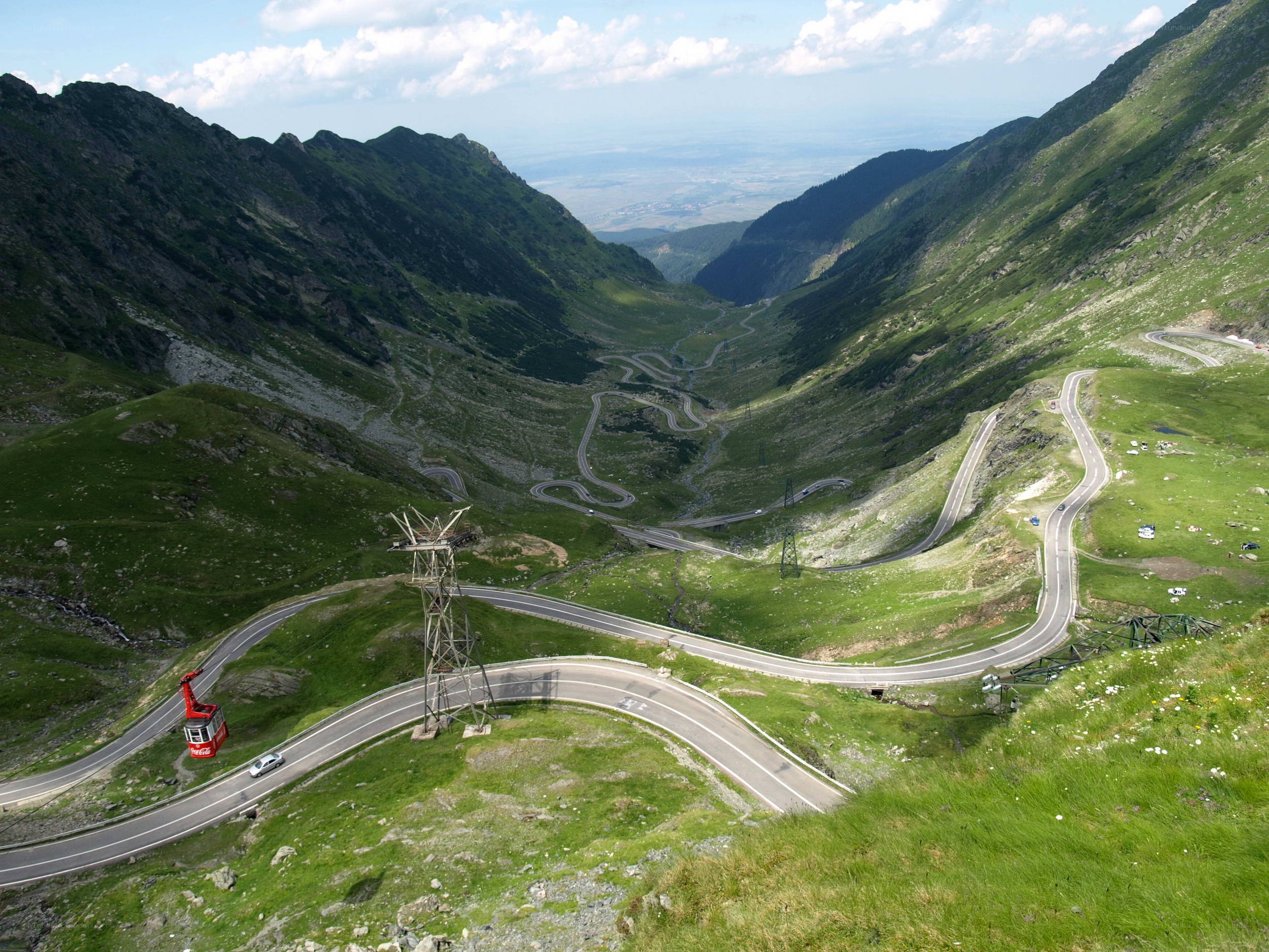 winding mountain road with cable car
