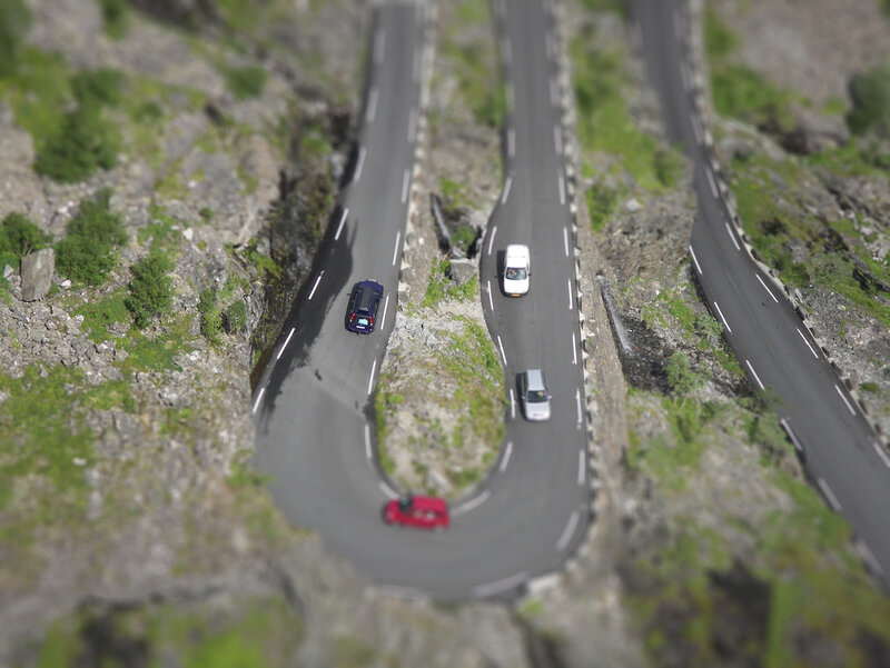 winding mountain road with cars