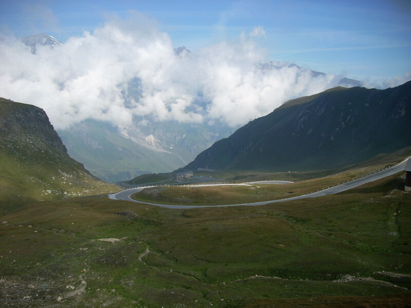 Winding mountain road with clouds