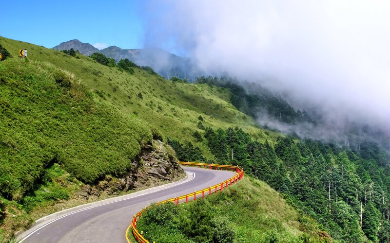 winding mountain road with fog