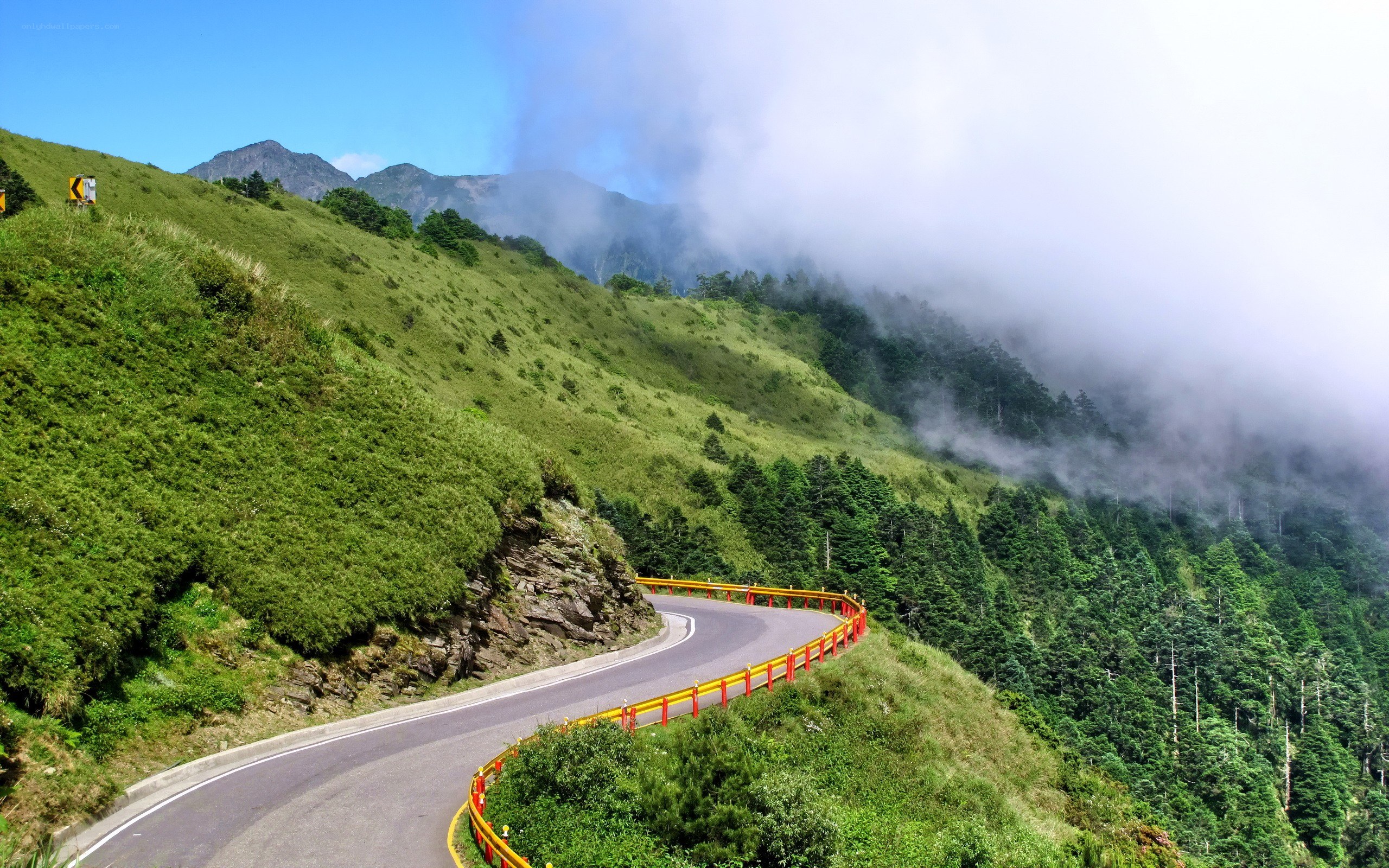 winding mountain road with fog