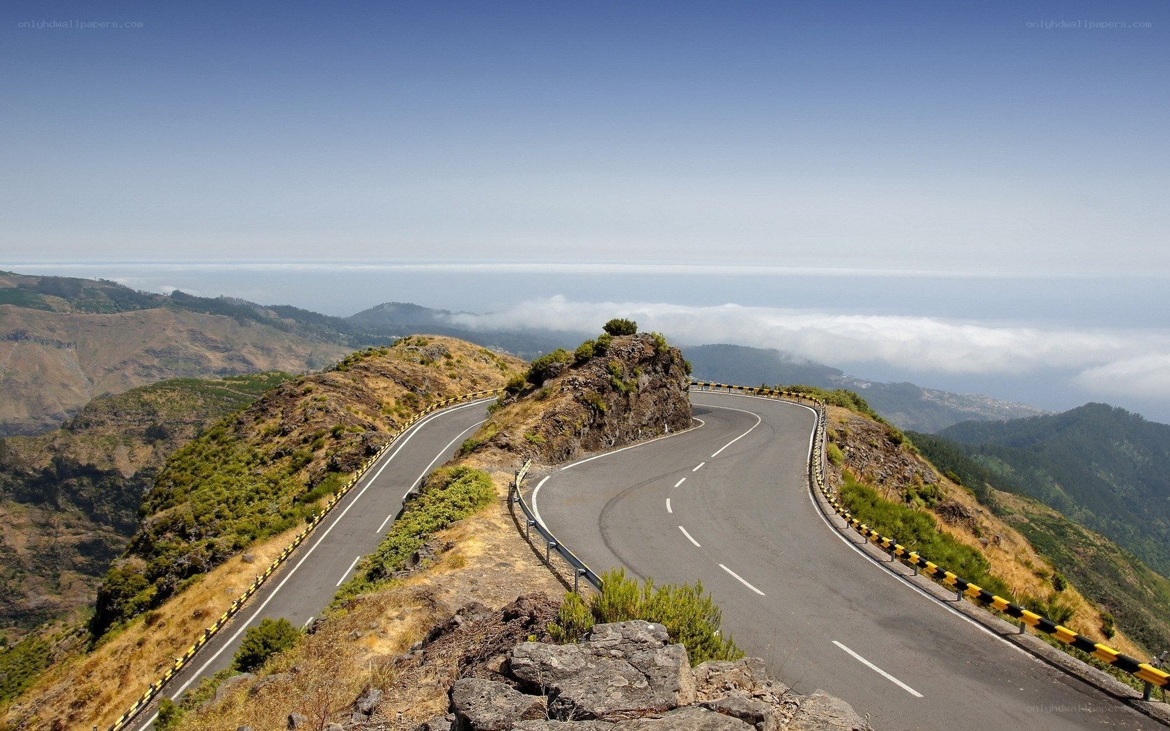 Winding mountain road with ocean view