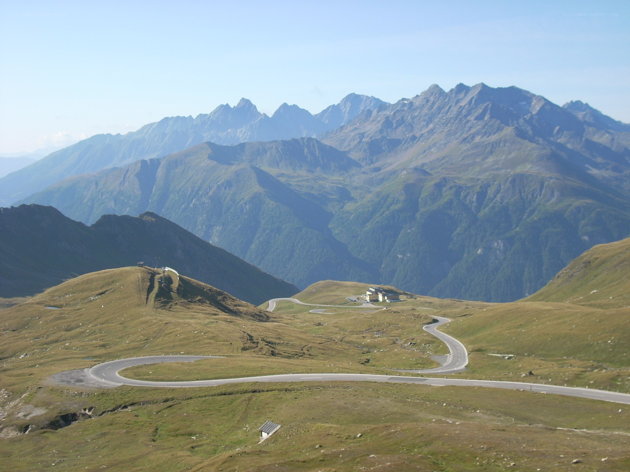 Winding mountain road with peaks