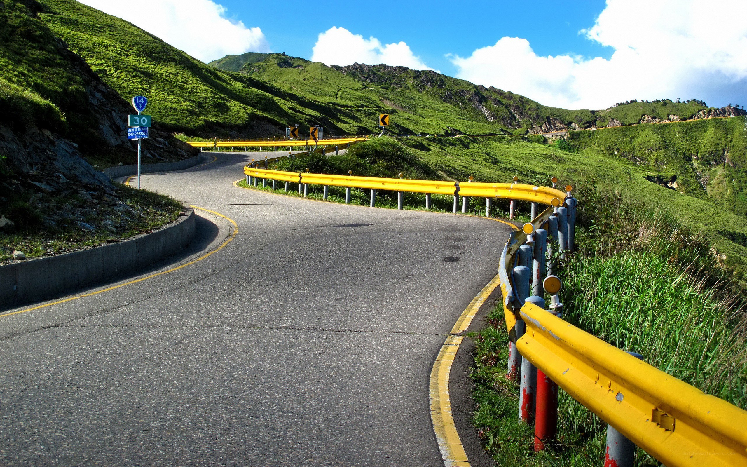 Winding mountain road with yellow guardrails