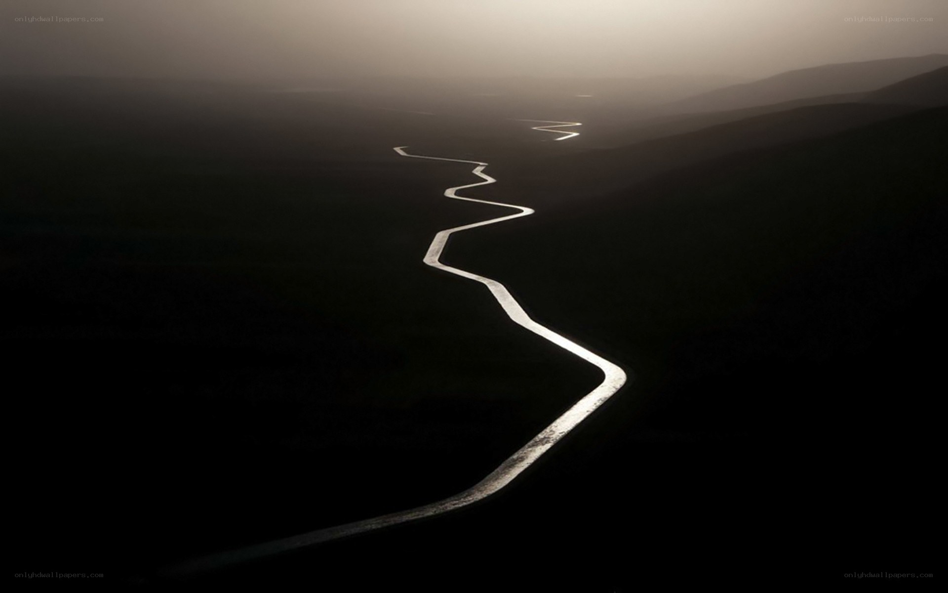 Winding river in misty landscape