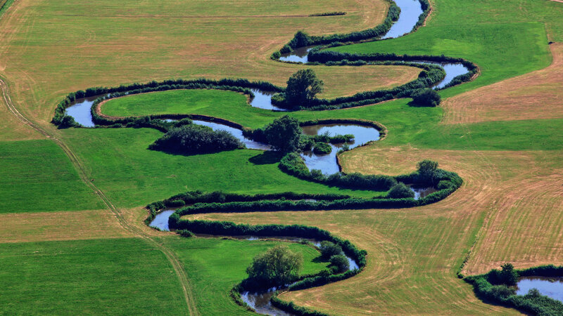 Winding River Through Fields