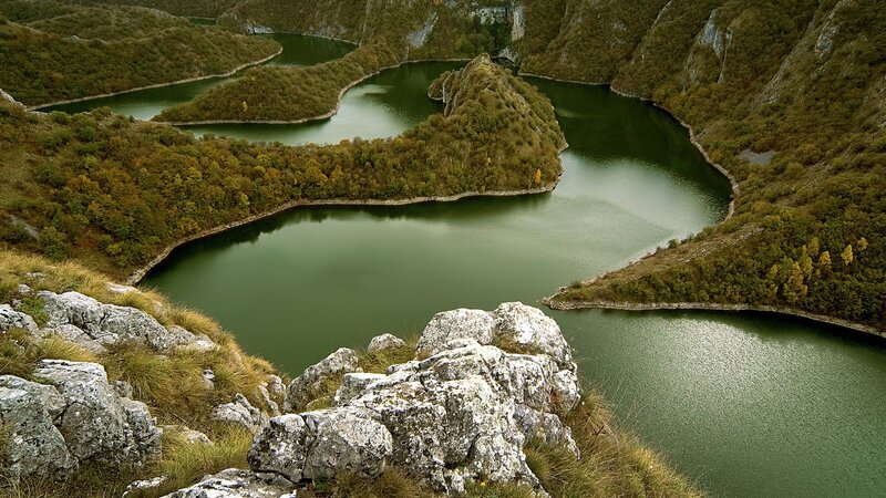 Winding river through forested hills