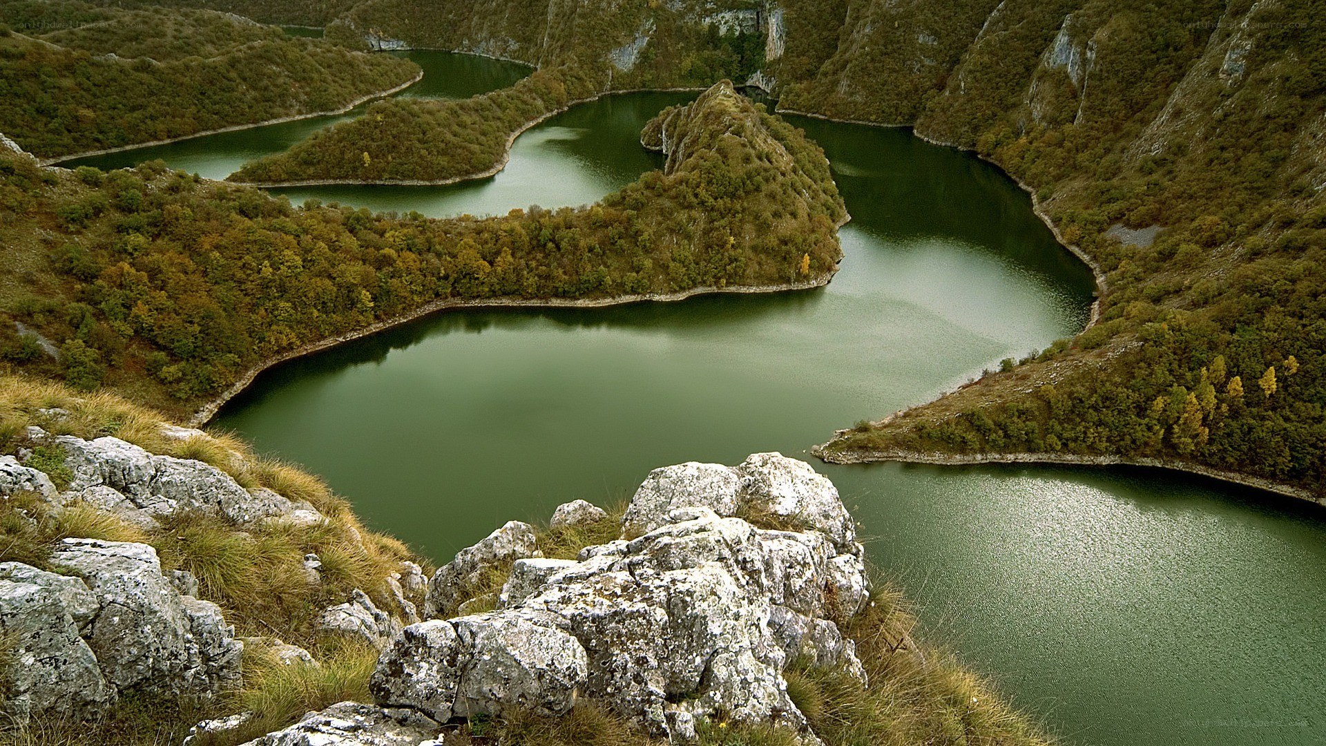 Winding river through forested hills