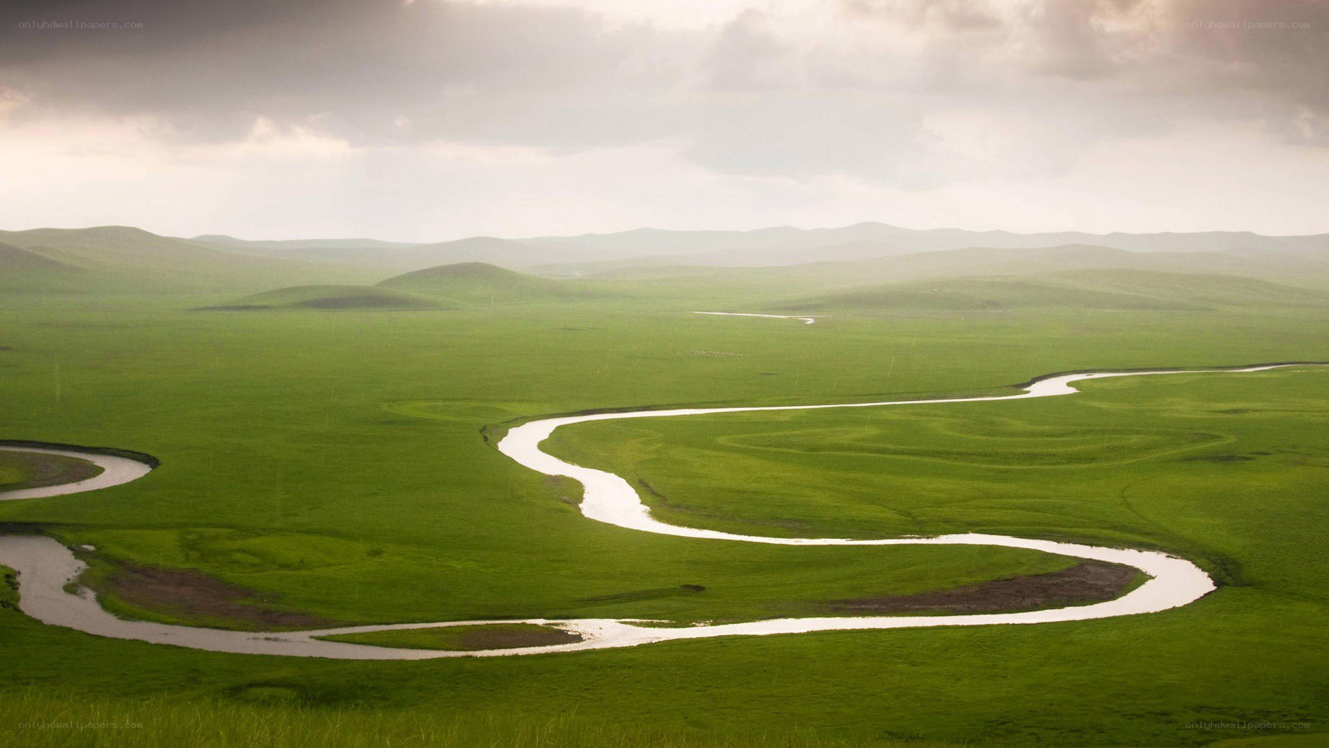 Winding river through green plains