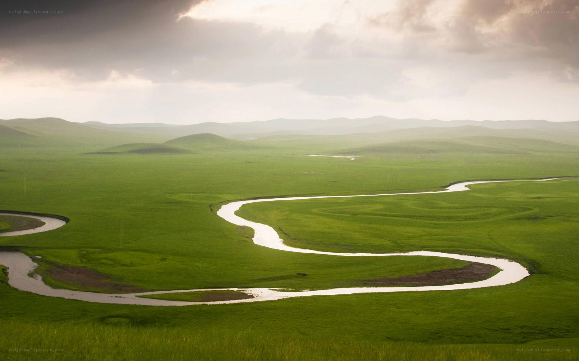 Winding river through green plains