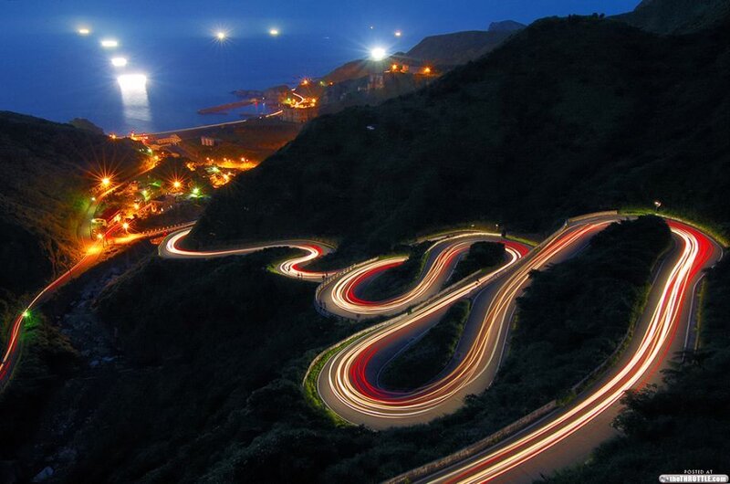 Winding Road at Night — Black, Dramatic, Photograph, Mountain, Sea, Lights, Town