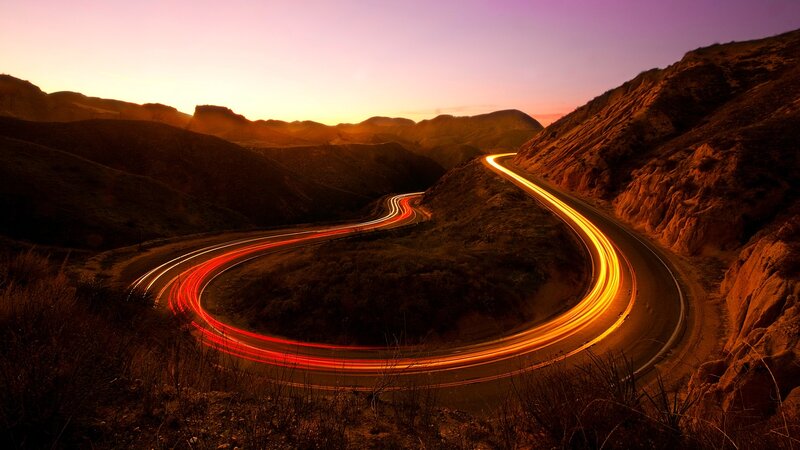 Winding Road at Sunset — Orange, Dramatic, Photograph, Mountains, Light Trails