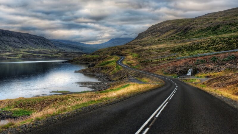 Winding road by a lake in Iceland