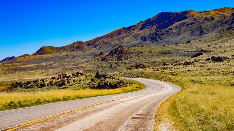 Winding Road in Desert — Blue, Serene, Afternoon, Photograph, Mountains