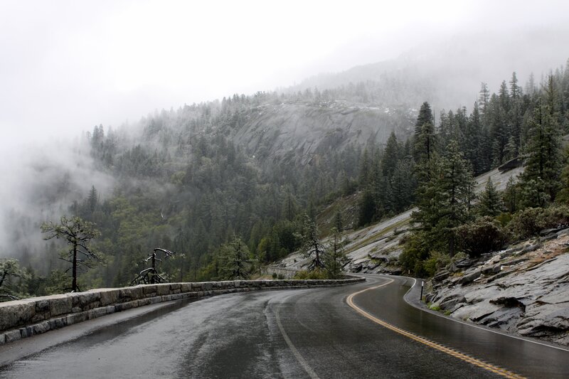 Winding road in foggy mountains