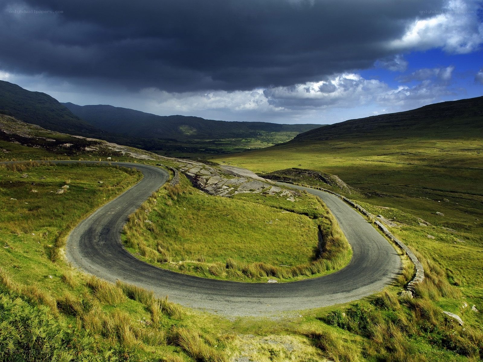 Winding road in green hills