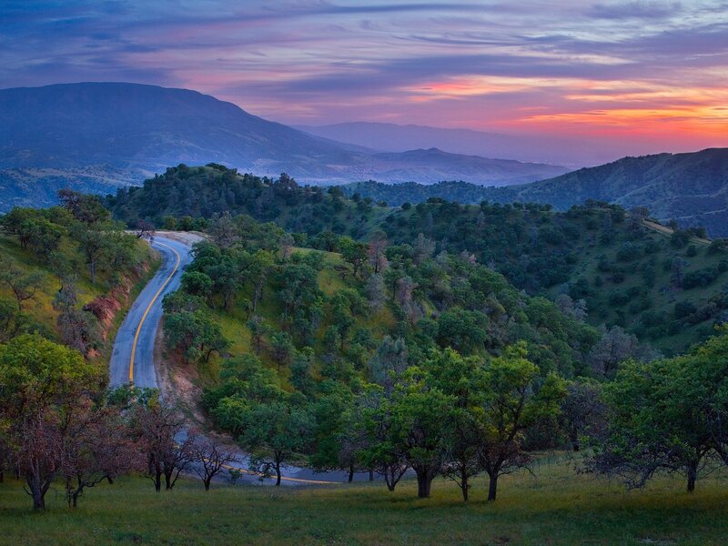 Winding Road in Hills — Green, Serene, Sunset, Photograph, Mountains, Trees