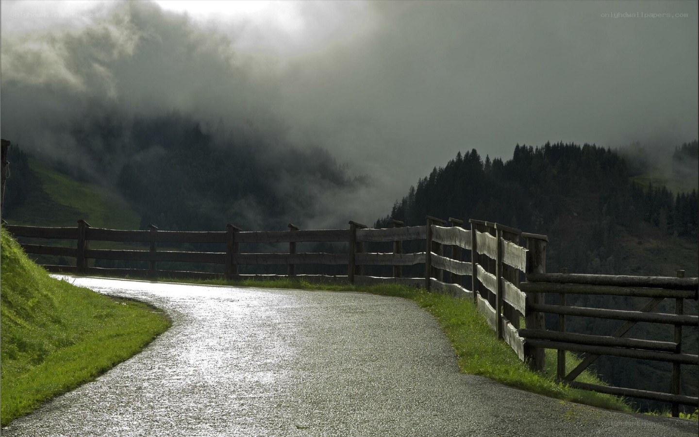Winding road in misty mountains