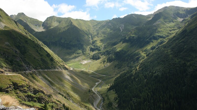 Winding Road in Mountain Valley — Green, Serene, Afternoon, Photograph