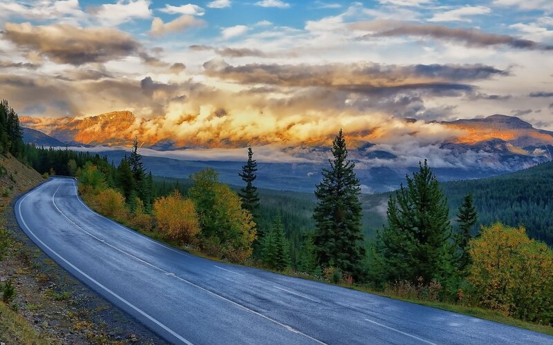 Winding Road in Mountains — Blue, Dramatic, Sunset, Photograph, Trees, Clouds