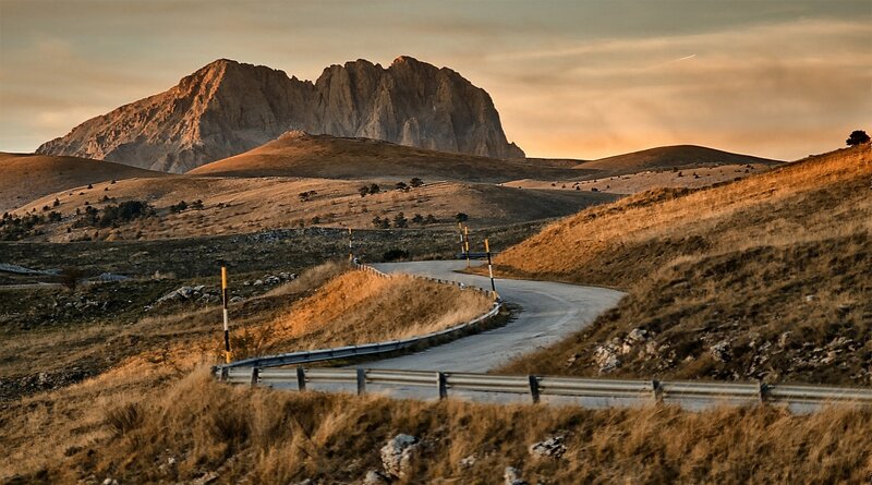 Winding Road in Mountains — Brown, Serene, Sunset, Photograph, Mountain
