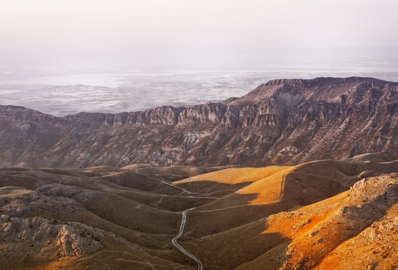 Winding Road in Mountains — Brown, Serene, Sunset, Photograph, Valley