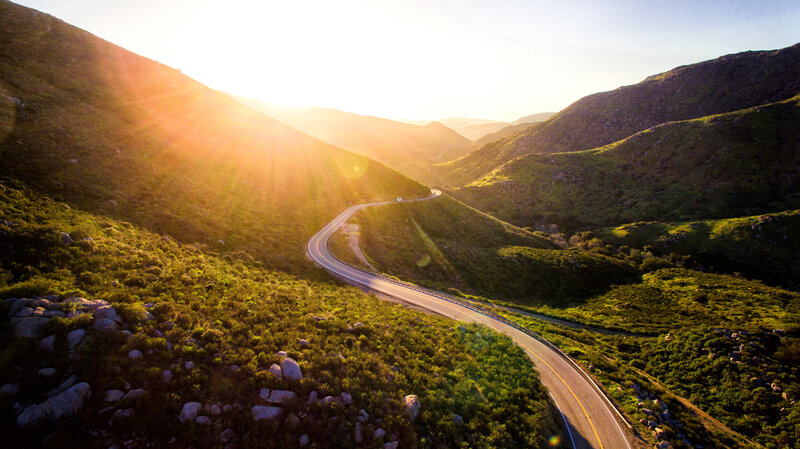Winding Road in Mountains — Green, Serene, Sunset
