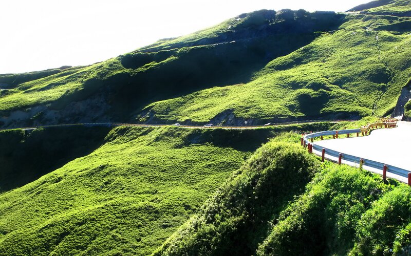 Winding road on green hills