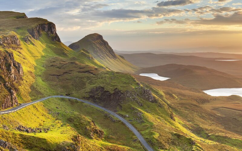 Winding road on green hills