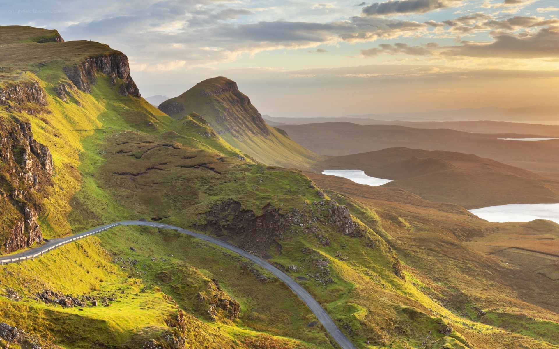 Winding road on green hills