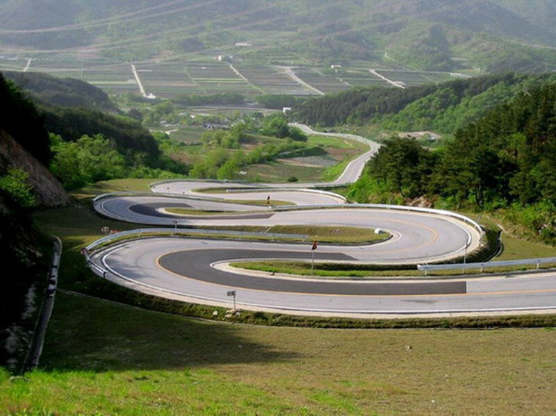 Winding Road on Hillside — Green, Serene, Afternoon