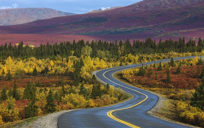 Winding road through autumn mountains