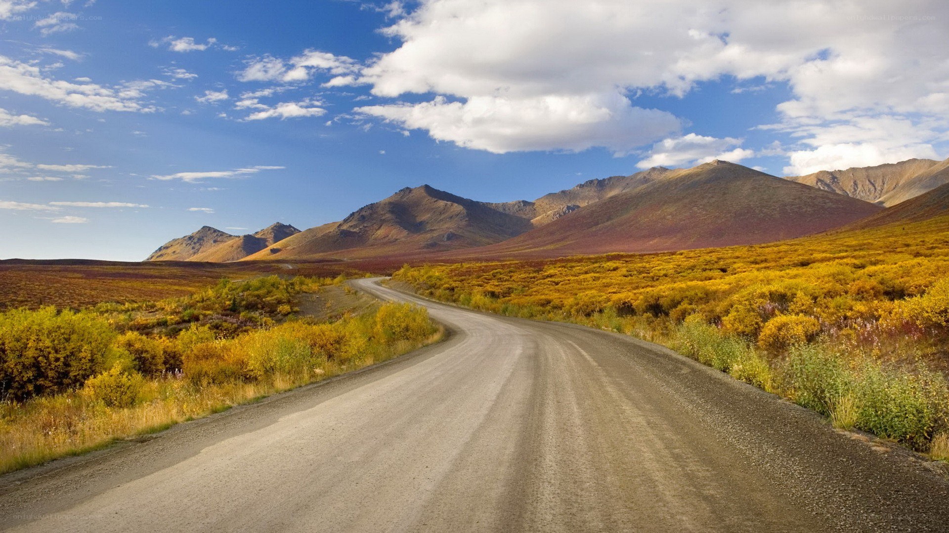 Winding road through autumn mountains