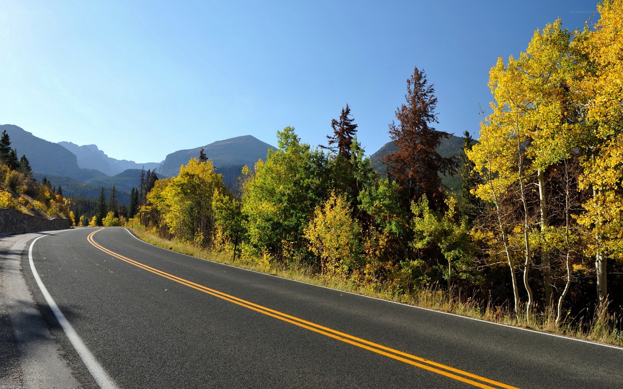 Winding road through autumn mountains