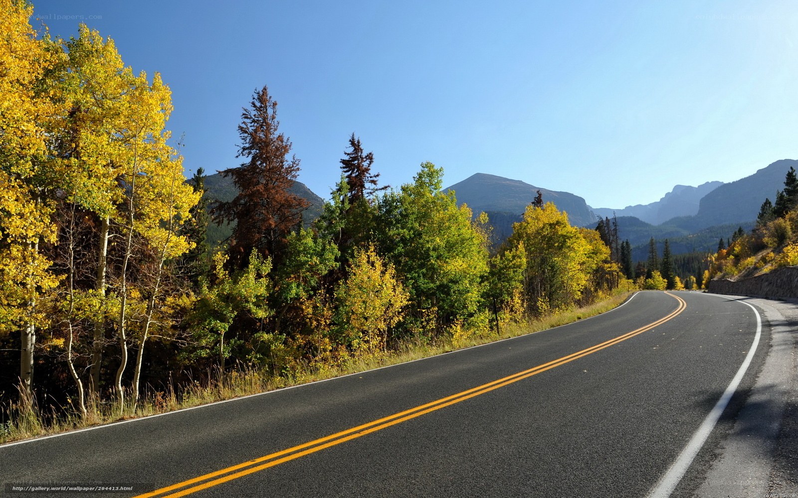 Winding road through autumn mountains