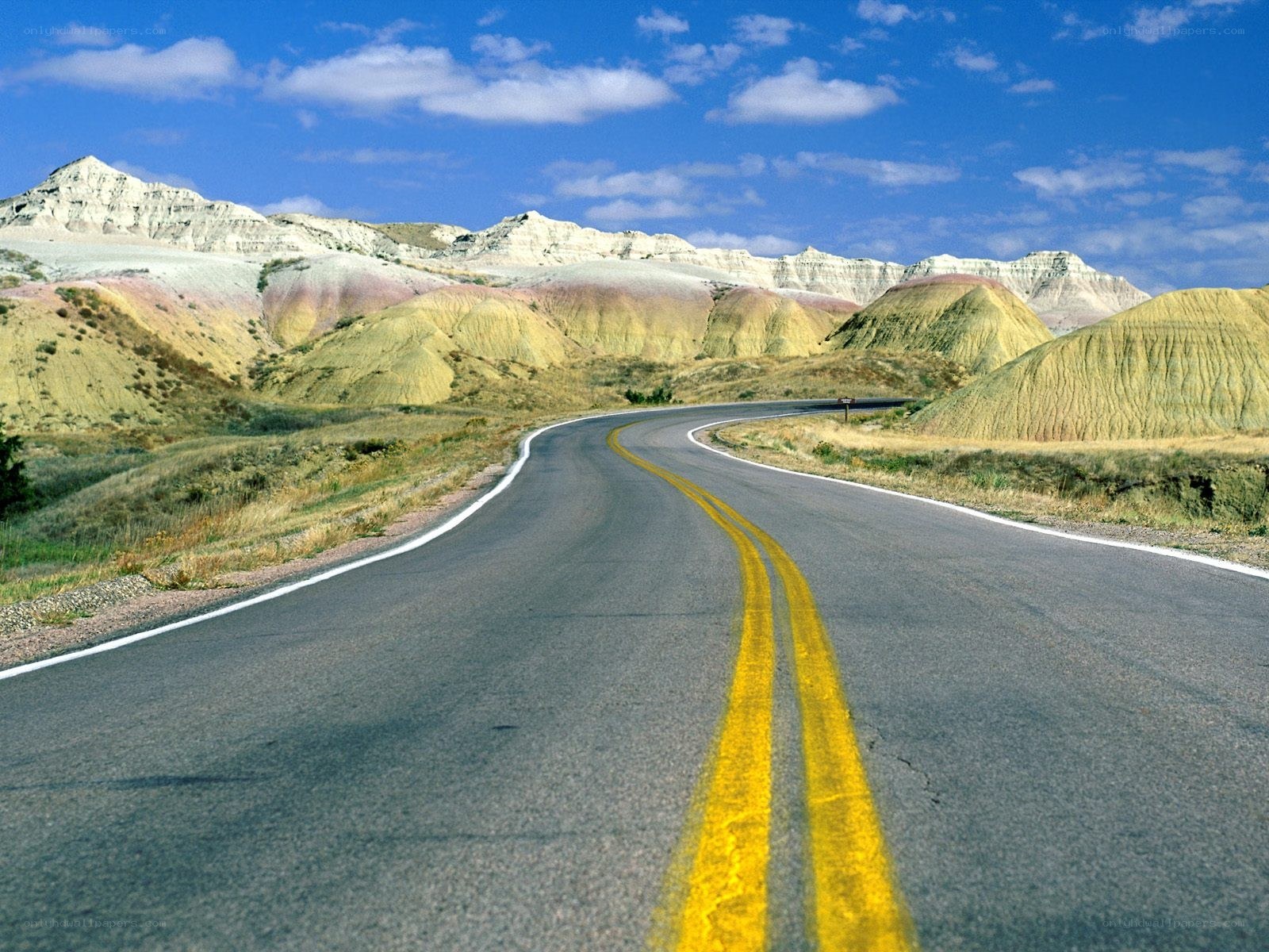 Winding road through colorful badlands