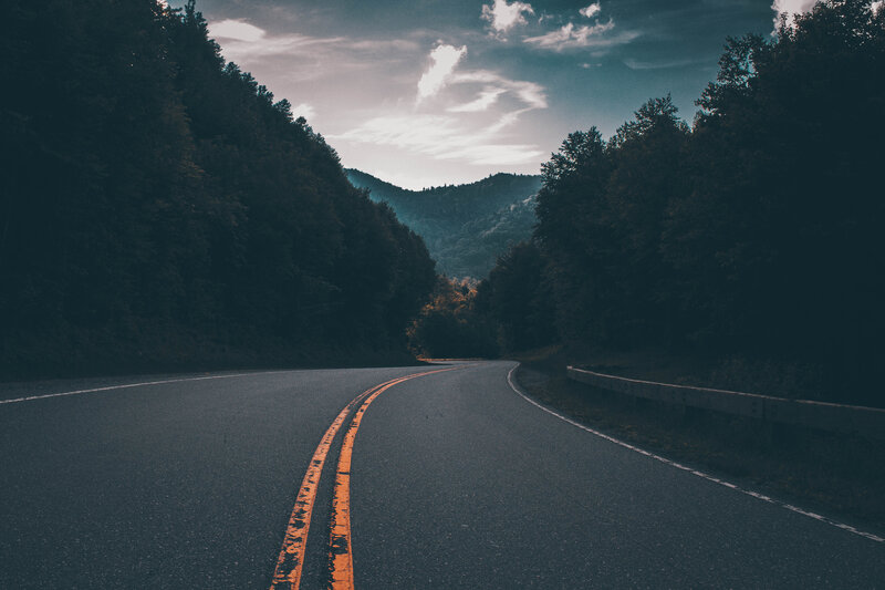 Winding road through forested mountains