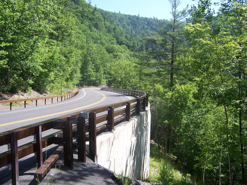 Winding road through forested valley