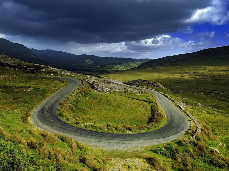 Winding road through green hills
