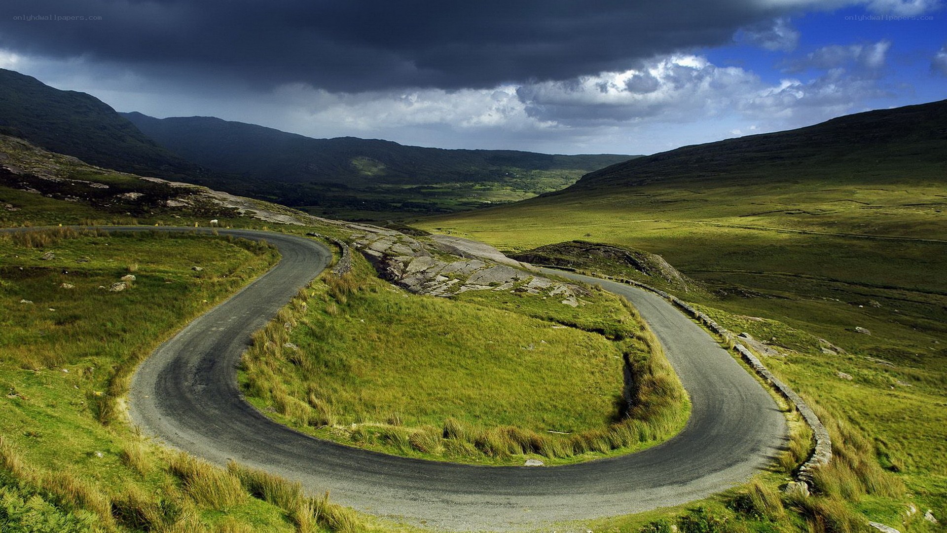Winding road through green hills