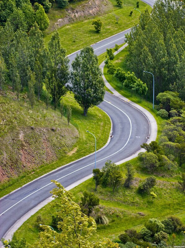 Winding road through green hills