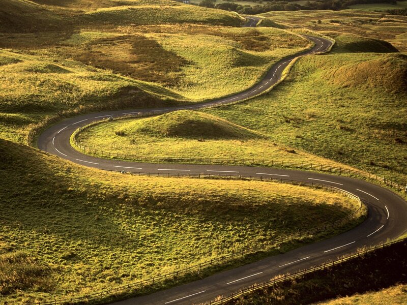 Winding road through green hills