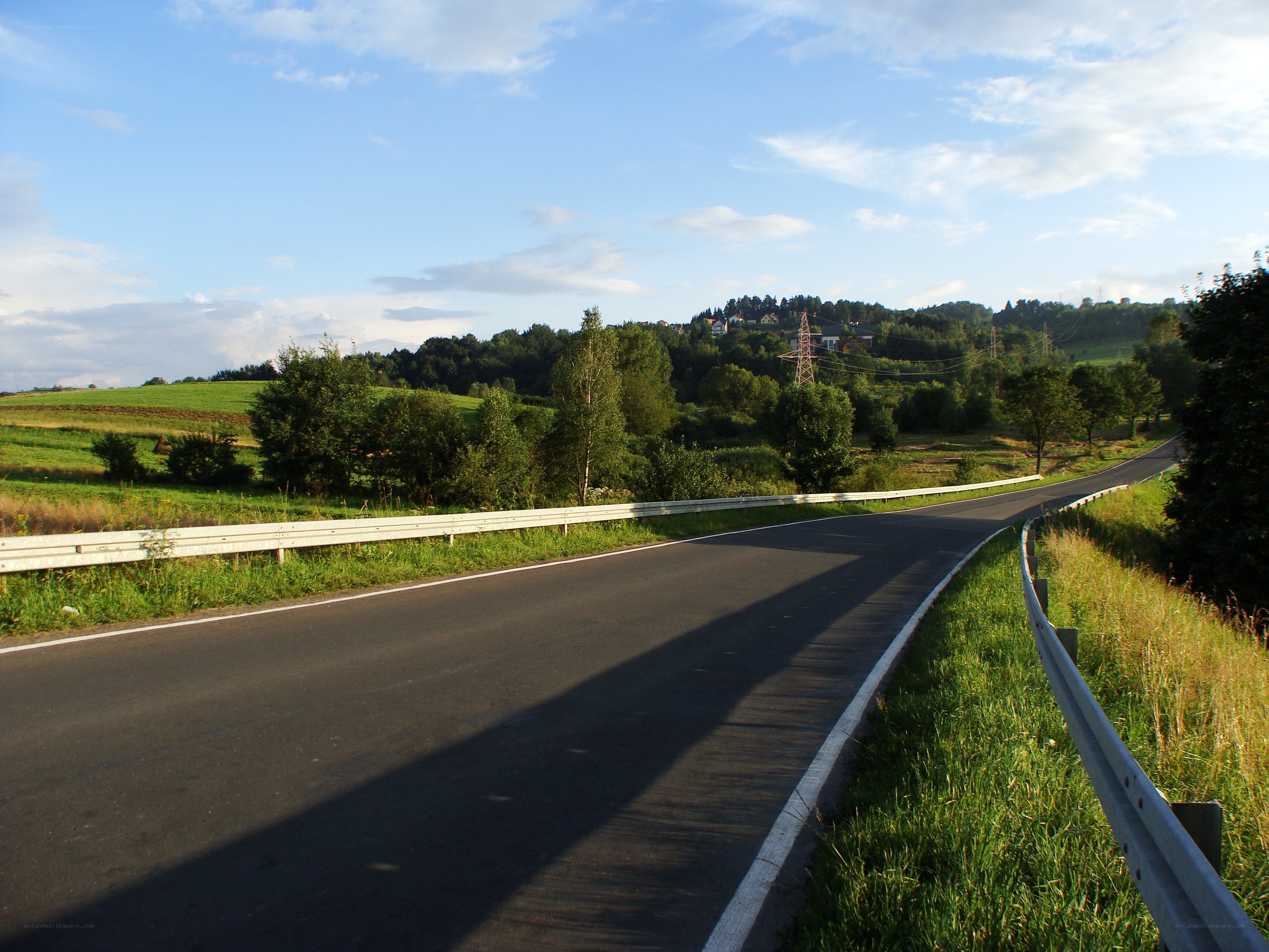 Winding road through green hills